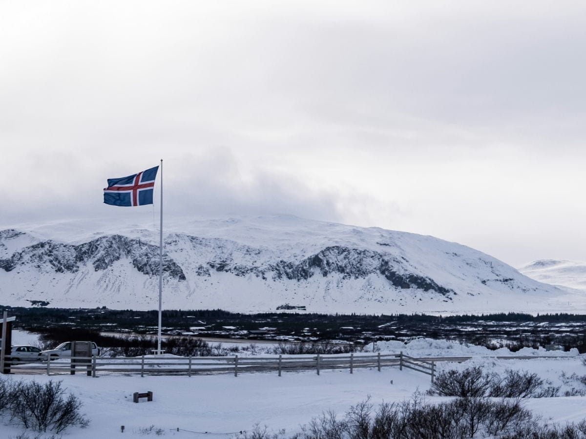 Icelandic flag over a snow-covered landscape